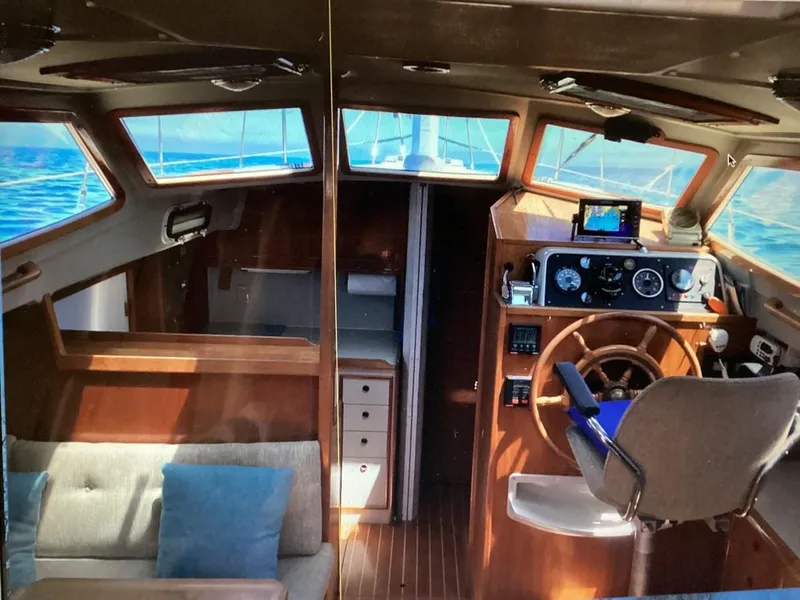 Slide: The Image of Interior of 1986 Nautilus Pilothouse 36, featuring helm and seating area. - 9