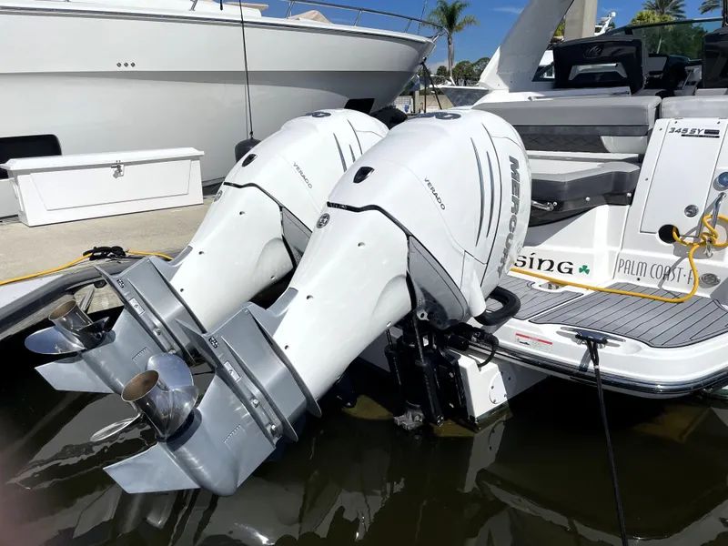 Slide: The Image of 2020 Monterey 345 Sport Yacht with twin outboard engines docked at marina. - 12