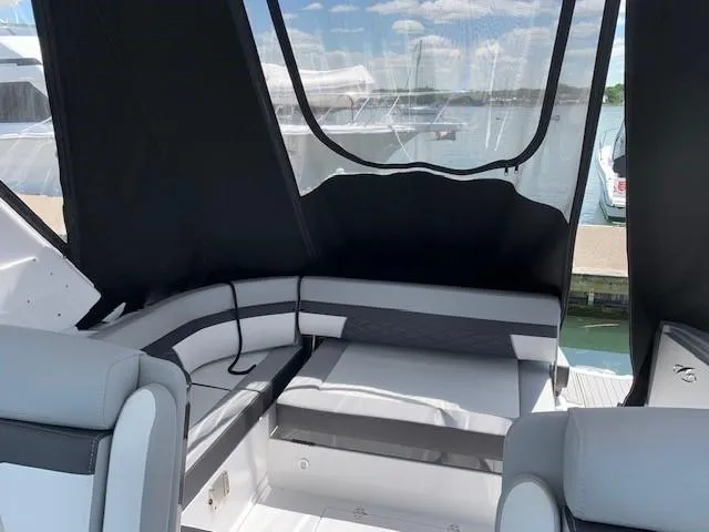Slide: The Image of 2020 Monterey 345 Sport Yacht interior with cushioned seating and waterfront view. - 15