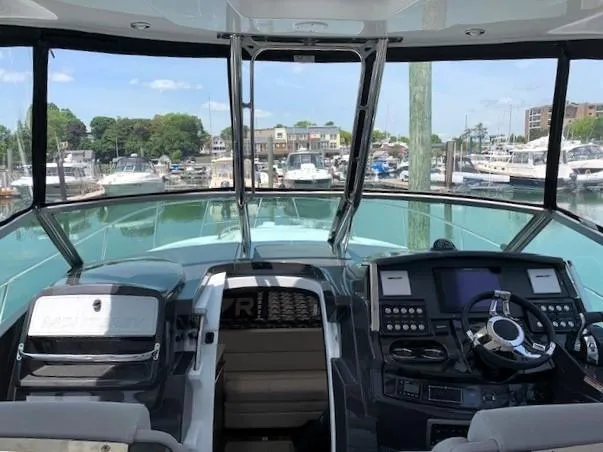 Slide: The Image of 2020 Monterey 345 Sport Yacht helm with marina view. - 16