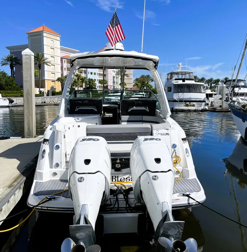 Slide: The Image of 2020 Monterey 345 Sport Yacht docked at marina with American flag. - 2