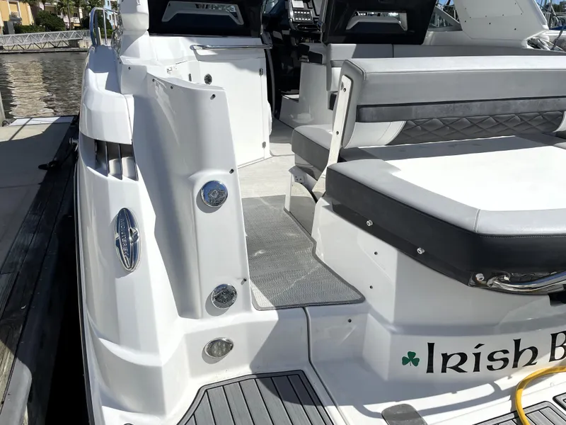Slide: The Image of 2020 Monterey 345 Sport Yacht, rear seating area, docked, with "Irish B" name visible. - 24