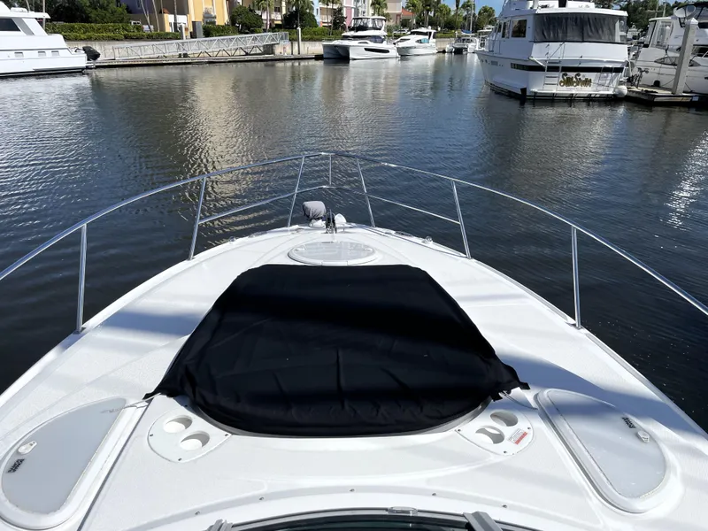 Slide: The Image of 2020 Monterey 345 Sport Yacht on calm marina waters, showcasing sleek design and spacious deck. - 38