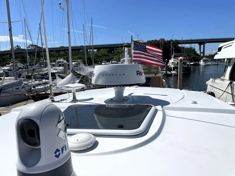 Slide: The Image of Monterey 345 Sport Yacht 2020 on marina, featuring radar and American flag. - 39