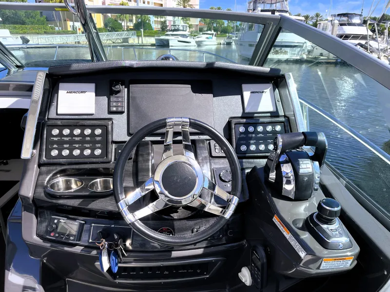 Slide: The Image of 2020 Monterey 345 Sport Yacht helm with modern controls and steering wheel. - 43