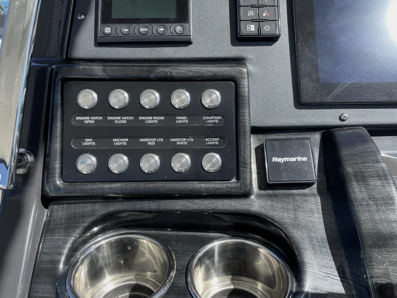 Slide: The Image of Control panel of 2020 Monterey 345 Sport Yacht with switches and Raymarine device. - 48