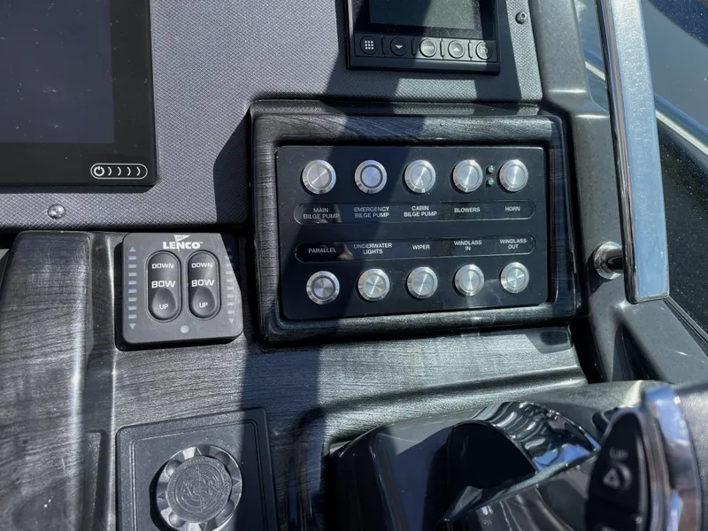 Slide: The Image of Control panel of 2020 Monterey 345 Sport Yacht with various switches and buttons. - 49