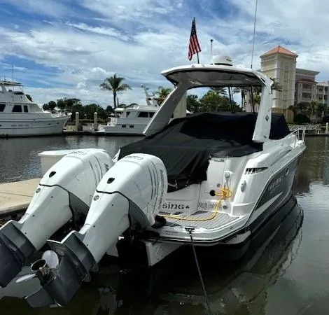 Slide: The Image of 2020 Monterey 345 Sport Yacht docked at marina, featuring twin outboard engines. - 7