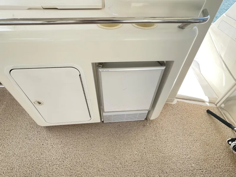 Slide: The Image of 1998 Sea Ray 420 Aft Cabin interior with storage and mini fridge. - 10