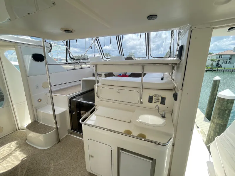 Slide: The Image of 1998 Sea Ray 420 Aft Cabin yacht interior with sink and seating area. - 12