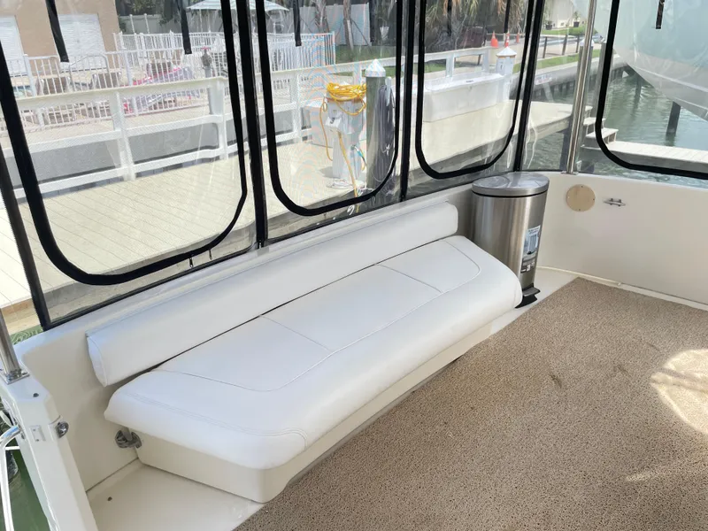 Slide: The Image of 1998 Sea Ray 420 Aft Cabin interior with white seating and carpeted floor. - 14