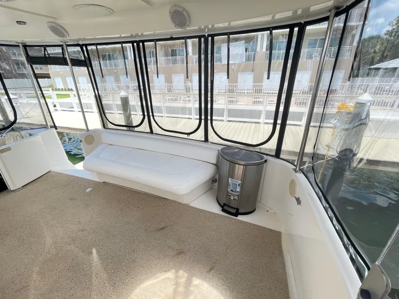Slide: The Image of 1998 Sea Ray 420 Aft Cabin interior with seating and windows overlooking marina. - 16