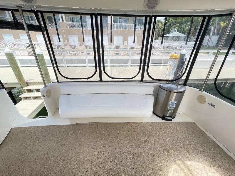 Slide: The Image of 1998 Sea Ray 420 Aft Cabin interior with white seating and large windows. - 17