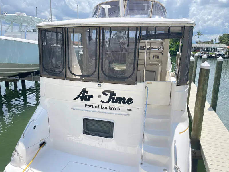 Slide: The Image of 1998 Sea Ray 420 Aft Cabin yacht docked, named "Air Time," Port of Louisville. - 3