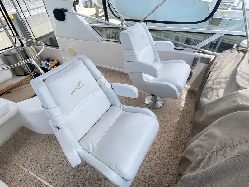 Slide: The Image of White captain chairs on 1998 Sea Ray 420 Aft Cabin yacht deck. - 31