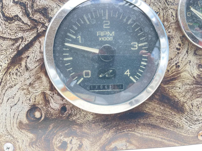 Slide: The Image of 1998 Sea Ray 420 Aft Cabin RPM gauge on a wood-patterned dashboard. - 36