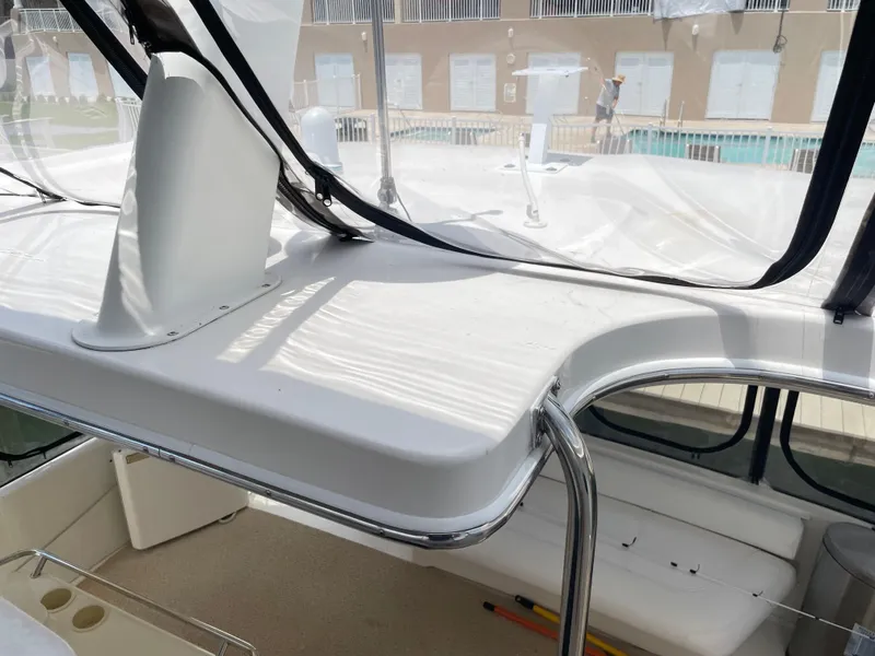 Slide: The Image of 1998 Sea Ray 420 Aft Cabin interior with white seating and clear canopy. - 42