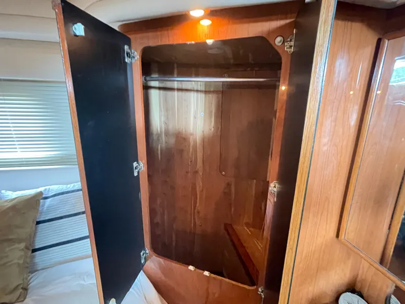 Slide: The Image of Wooden closet interior on 1998 Sea Ray 420 Aft Cabin yacht. - 48