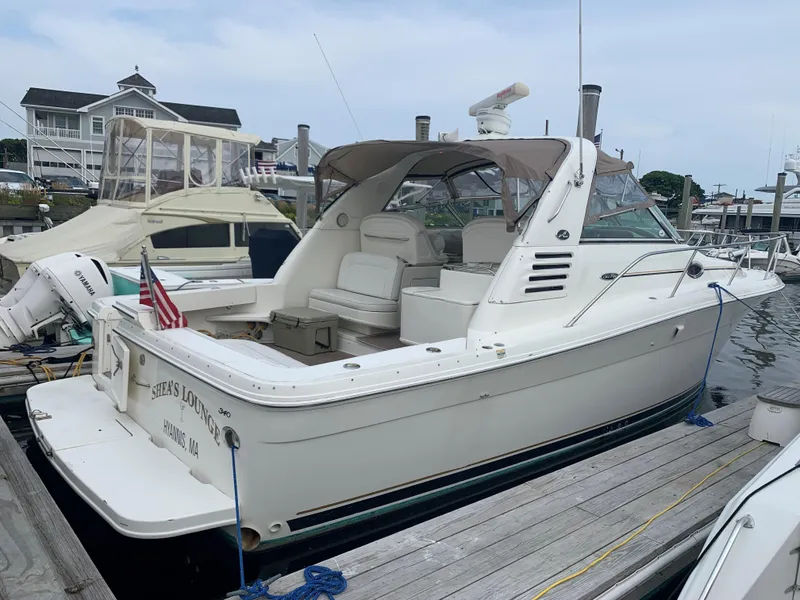 Slide: The Image of 2001 Sea Ray 340 Amberjack docked at marina with American flag. - 1