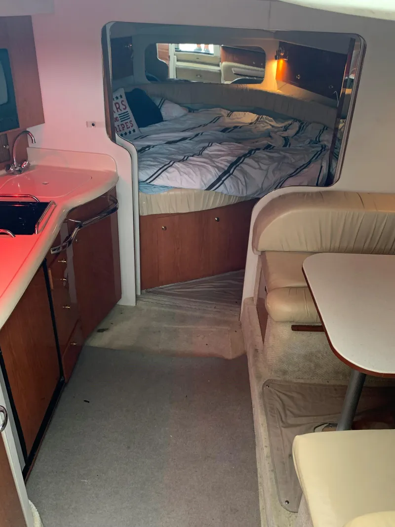 Slide: The Image of Interior of 2001 Sea Ray 340 Amberjack boat with kitchen, dining area, and bed. - 11