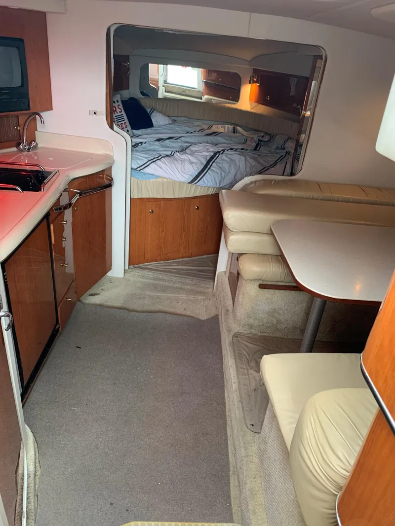 Slide: The Image of Interior of 2001 Sea Ray 340 Amberjack with kitchen, dining area, and sleeping quarters. - 12