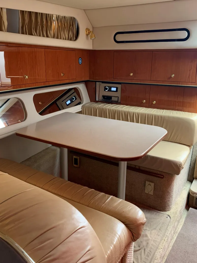 Slide: The Image of Interior of 2001 Sea Ray 340 Amberjack with dining area and wooden cabinetry. - 13