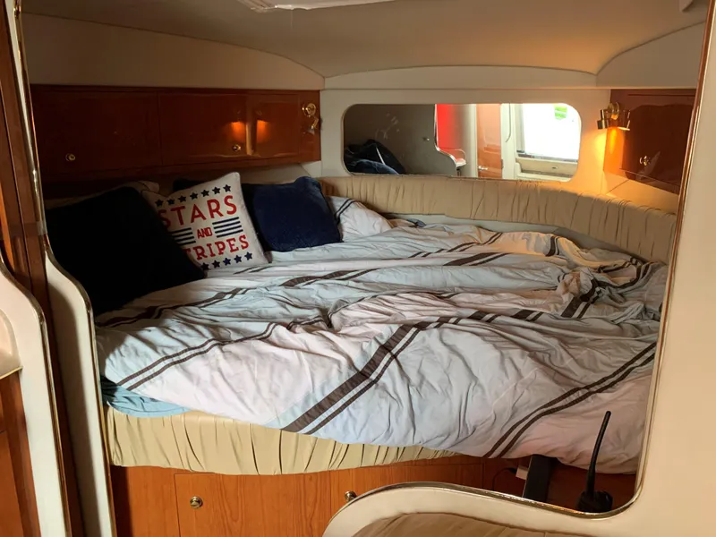 Slide: The Image of Interior cabin of 2001 Sea Ray 340 Amberjack with cozy bed and nautical decor. - 16