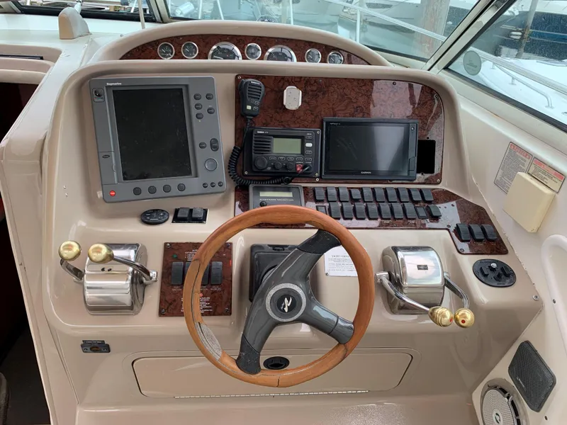 Slide: The Image of 2001 Sea Ray 340 Amberjack helm with navigation equipment and wooden steering wheel. - 5