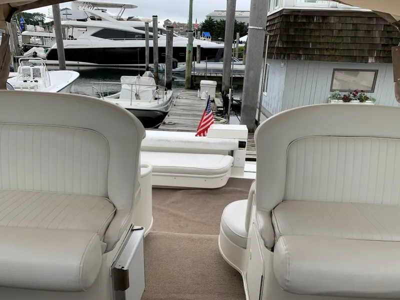 Slide: The Image of Interior view of a 2001 Sea Ray 340 Amberjack boat docked at a marina. - 7