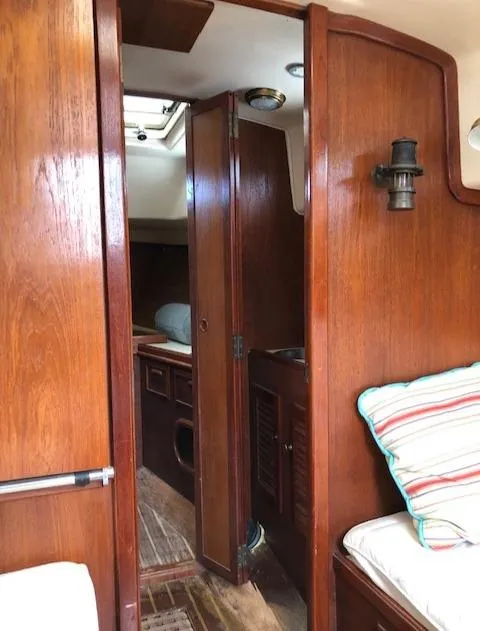 Slide: The Image of Interior of 1983 Cape Dory 28 sailboat with wooden finish and cozy seating. - 19
