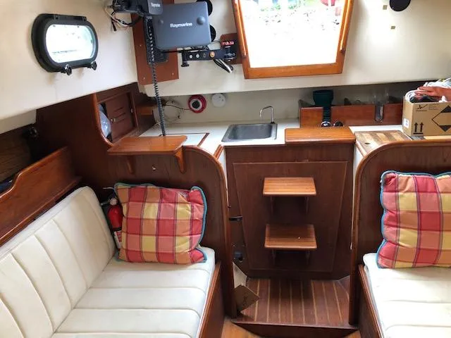 Slide: The Image of Interior of 1983 Cape Dory 28 sailboat with cozy seating and nautical decor. - 22