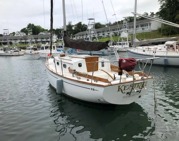 Slide: The Image of 1983 Cape Dory 28 sailboat docked in a marina, surrounded by other boats. - 3