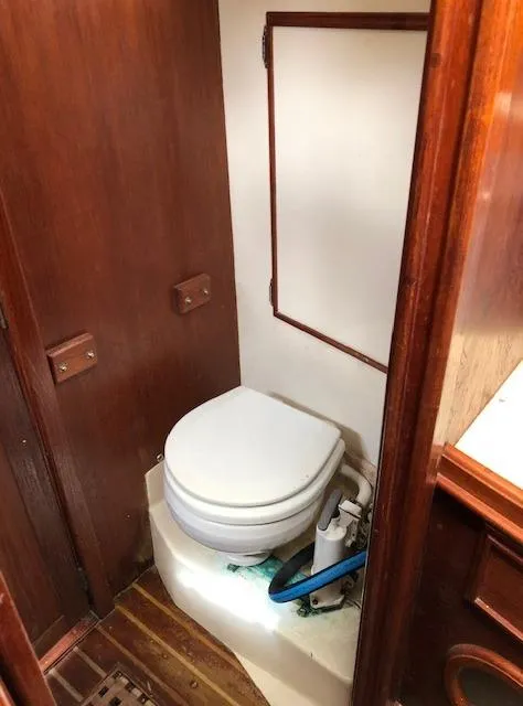 Slide: The Image of 1983 Cape Dory 28 boat bathroom with wooden interior and marine toilet. - 31