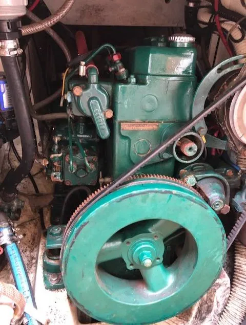 Slide: The Image of 1983 Cape Dory 28 engine, green, detailed view of mechanical components. - 34