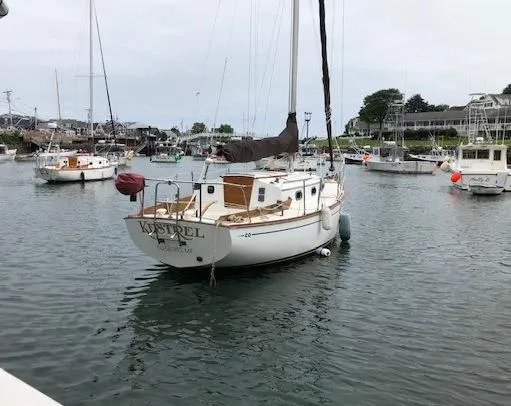 Slide: The Image of 1983 Cape Dory 28 sailboat docked in a marina, surrounded by other boats. - 4
