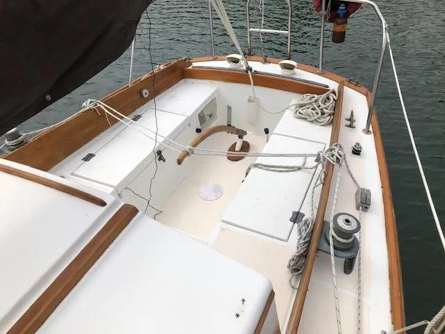 Slide: The Image of 1983 Cape Dory 28 sailboat cockpit with wooden trim and nautical ropes. - 6