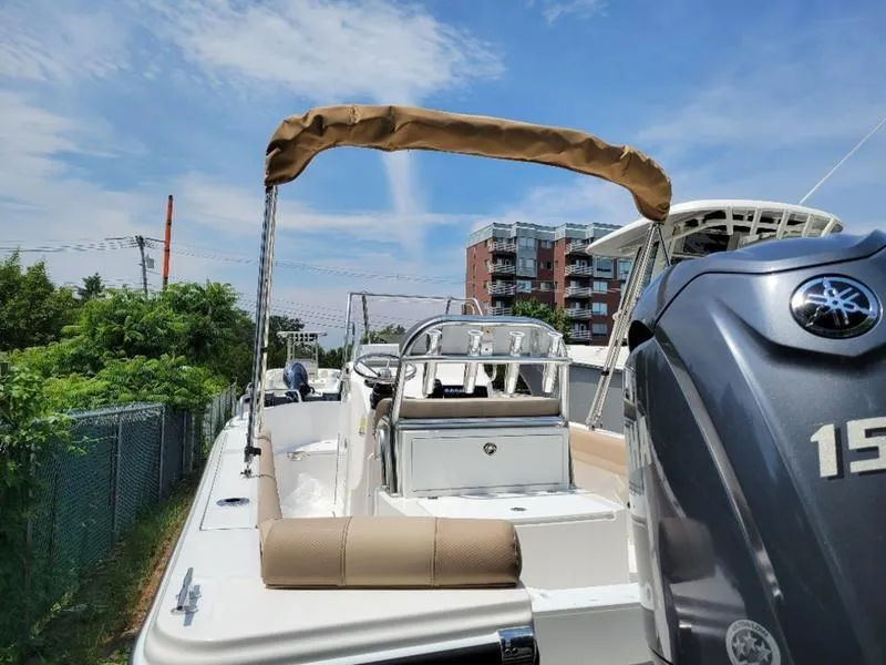 Slide: The Image of 2025 Edgewater 188 CC boat with Yamaha 150 engine, docked near buildings. - 2