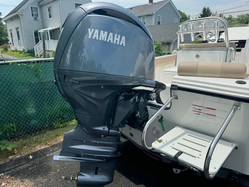 Slide: The Image of 2025 Edgewater 188 CC boat with Yamaha outboard motor in residential driveway. - 6