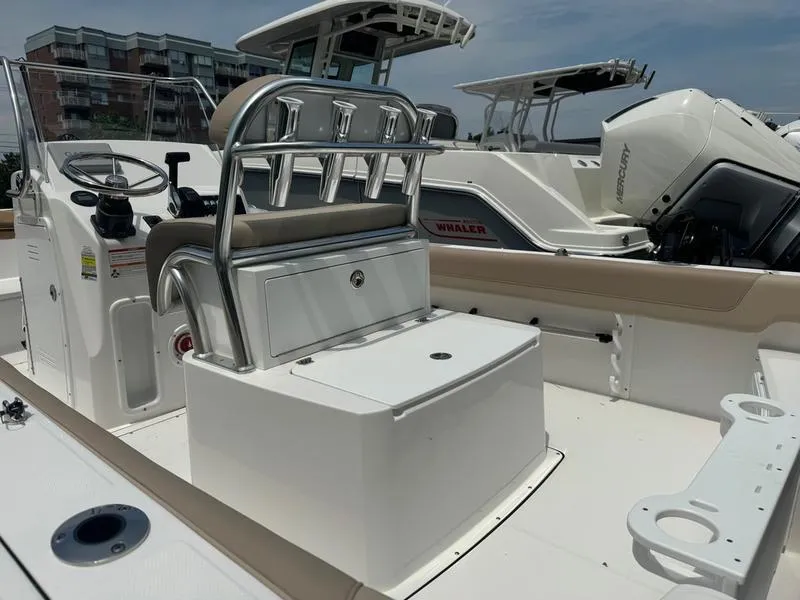 Slide: The Image of 2025 Edgewater 188 CC center console boat interior with seating and rod holders. - 7