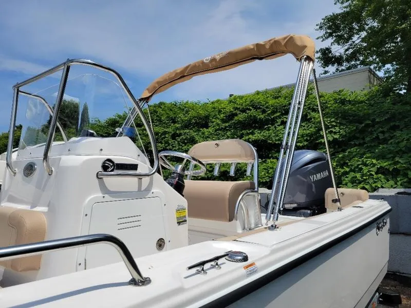 Slide: The Image of 2025 Edgewater 188 CC boat with Yamaha engine, beige seating, and canopy. - 8