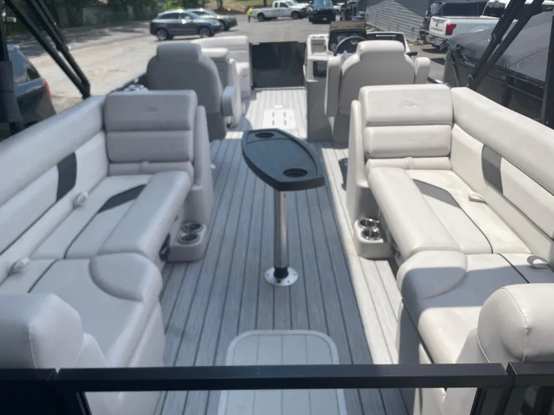 Slide: The Image of 2024 SunCatcher Select 324RC pontoon boat interior with spacious seating and table. - 11