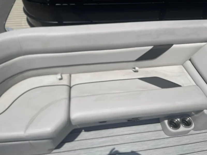 Slide: The Image of 2024 SunCatcher Select 324RC boat interior seating with cup holders. - 5