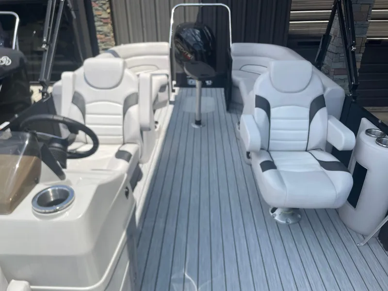 Slide: The Image of 2024 SunCatcher Select 324RC boat interior with white and gray seating. - 7