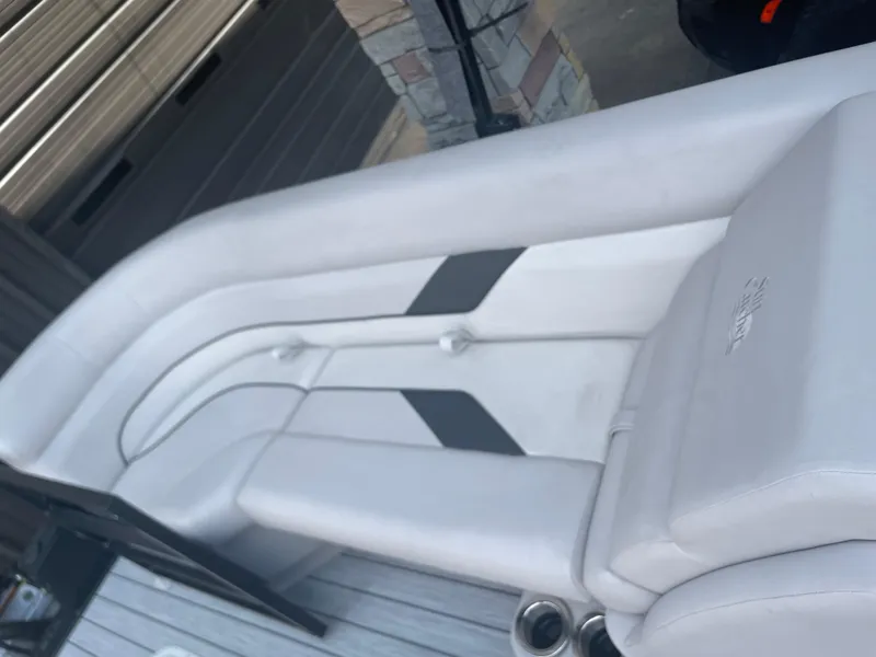 Slide: The Image of 2024 SunCatcher Select 324RC boat interior with white and gray seating. - 9