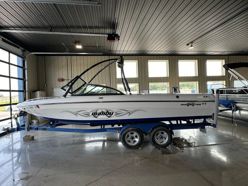The Image of 2003 Malibu Wakesetter 23 XTi boat on a trailer in a garage. - 0