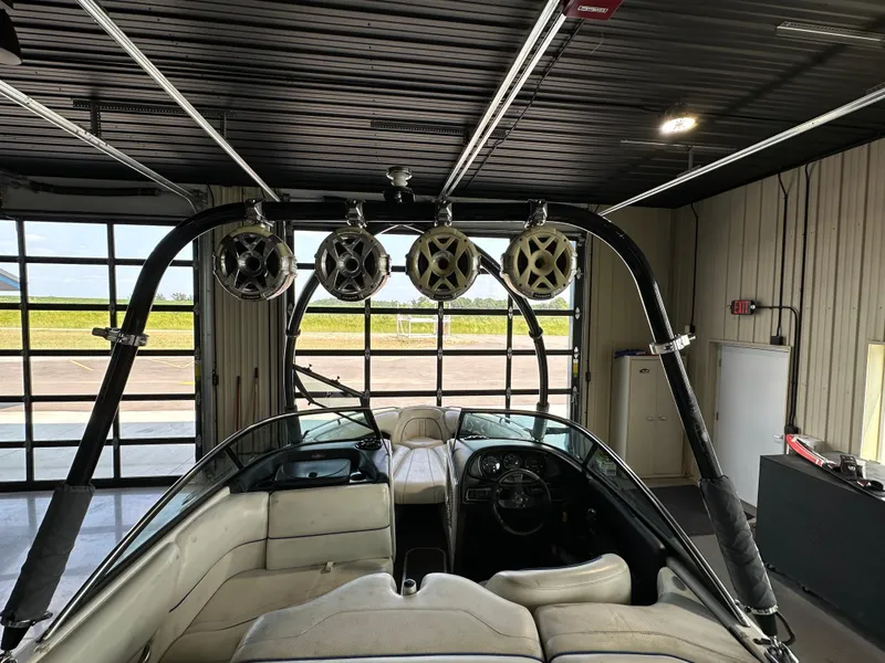 Slide: The Image of 2003 Malibu Wakesetter 23 XTi boat interior with wakeboard tower speakers in a garage. - 1