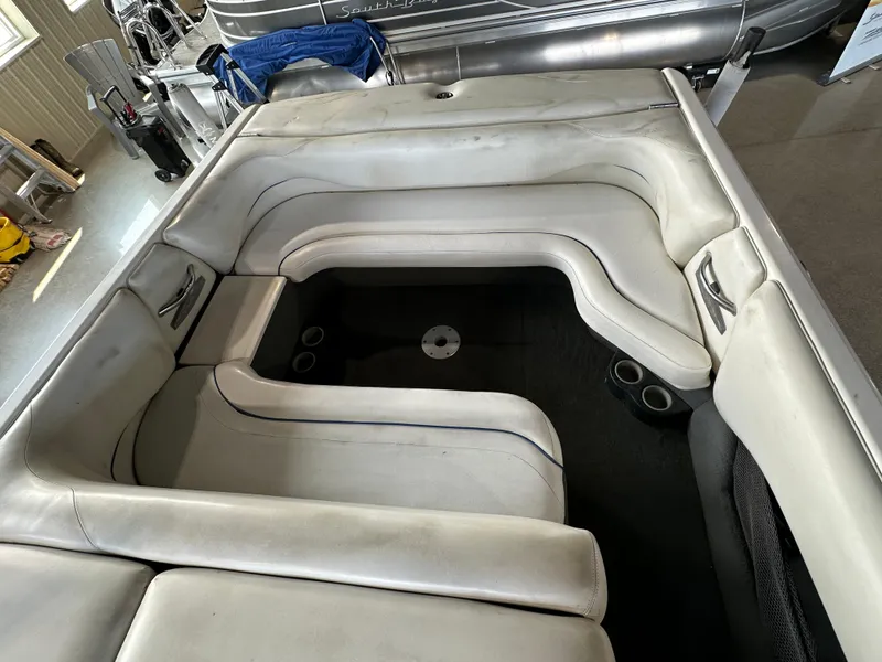 Slide: The Image of 2003 Malibu Wakesetter 23 XTi boat interior with white cushioned seating. - 2