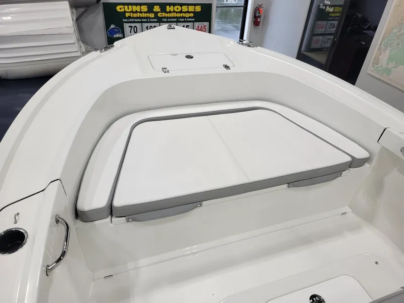 Slide: The Image of 2025 Parker 18 SE CC boat interior with cushioned seating and storage. - 11