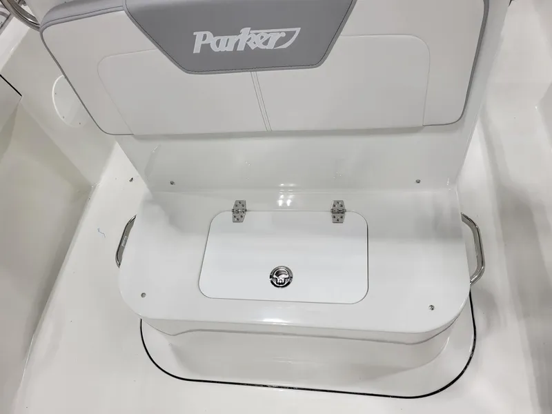 Slide: The Image of Parker 18 SE CC 2025 boat seat with storage compartment, white and gray design. - 12