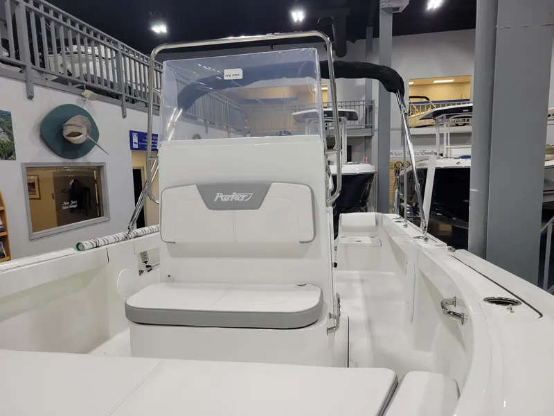 Slide: The Image of 2025 Parker 18 SE CC boat interior, white seating, showroom display. - 15